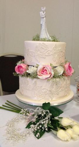 Fondant 2 tier Romantic Wedding Cake with lace and artificial flowers.