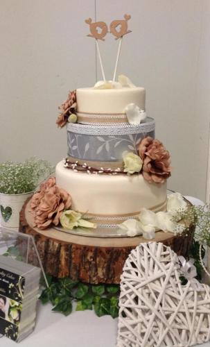 Fondant 3 tier rustic Wedding Cake with artificial flowers. Lace and Hessian ribbon.