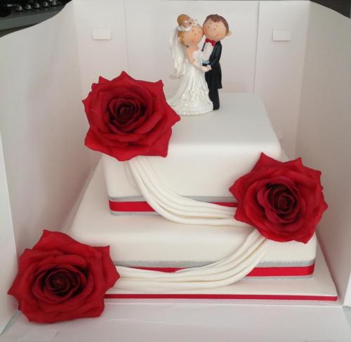 Fondant square 2 tier with icing drapes and large red sugar roses, silver and red ribbon Wedding Cake.